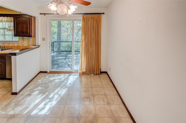 unfurnished dining area featuring plenty of natural light and ceiling fan