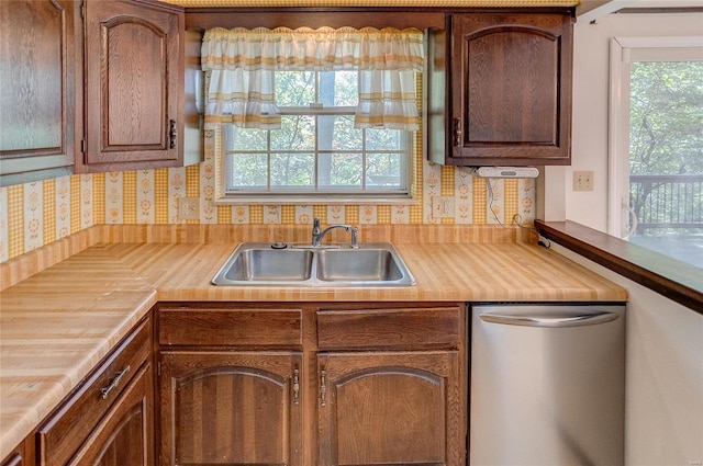 kitchen featuring dishwasher, tasteful backsplash, and sink