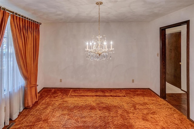 empty room with an inviting chandelier