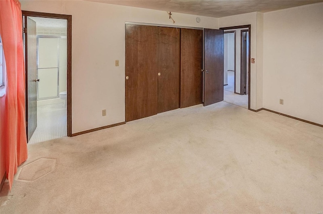 unfurnished bedroom with light carpet, a textured ceiling, and a closet