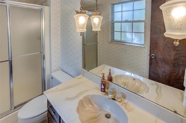 bathroom with vanity, toilet, and walk in shower