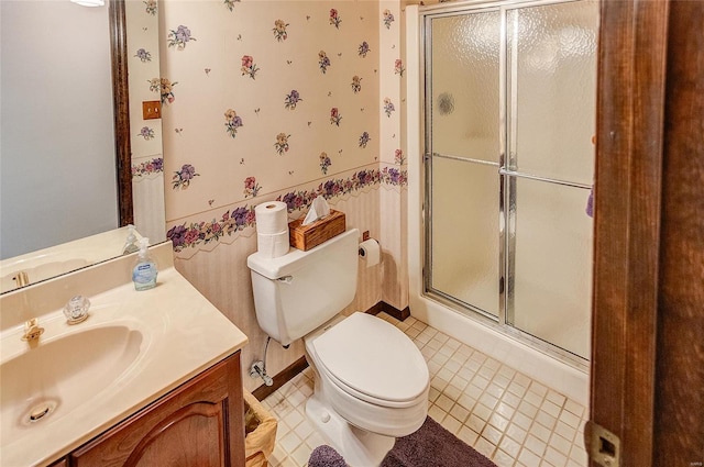 bathroom with vanity, an enclosed shower, toilet, and tile patterned flooring