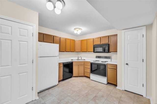 kitchen featuring light tile patterned floors, sink, and black appliances