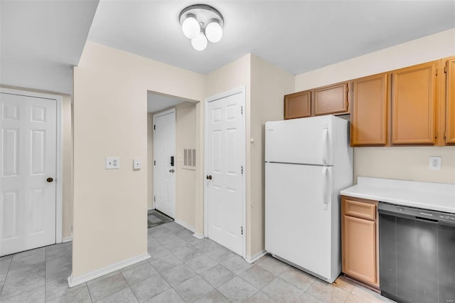 kitchen featuring white refrigerator, black dishwasher, and light tile patterned floors