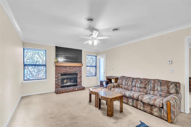 carpeted living room with crown molding, a brick fireplace, and ceiling fan