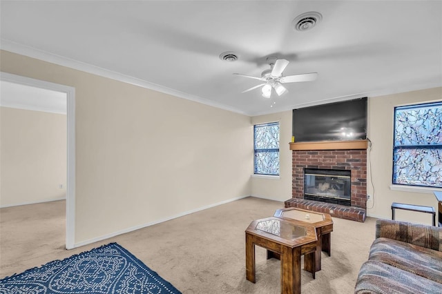 carpeted living room with a fireplace, ornamental molding, and ceiling fan