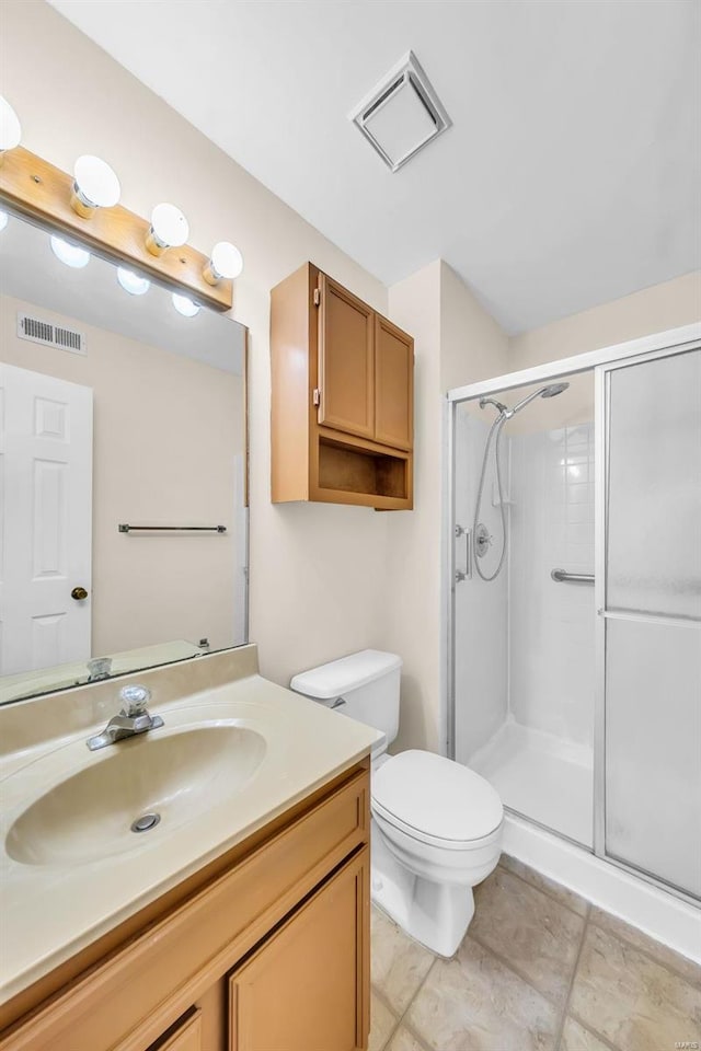 bathroom with vanity, toilet, and walk in shower