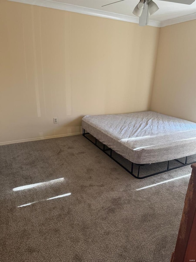 unfurnished bedroom featuring crown molding, carpet floors, and ceiling fan