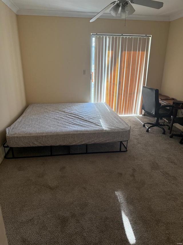 unfurnished bedroom with carpet floors, ornamental molding, and ceiling fan