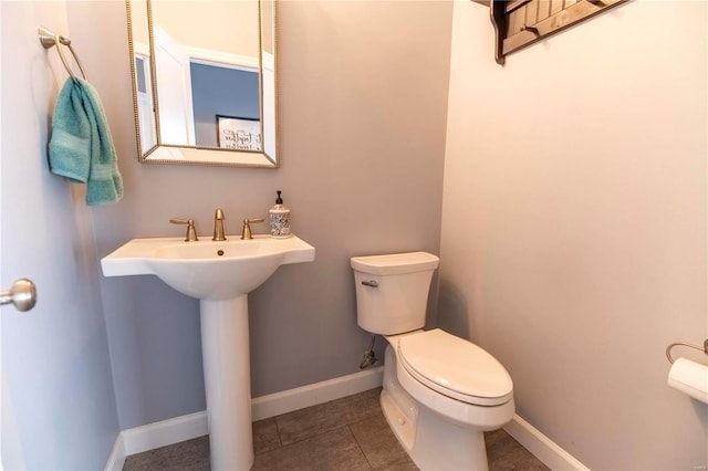 bathroom with sink, tile patterned flooring, and toilet