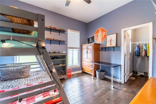 bedroom featuring ceiling fan, dark wood-type flooring, and a closet