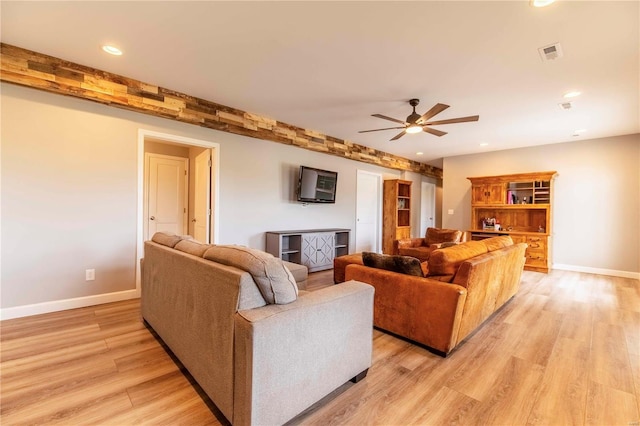 living room featuring light wood-type flooring and ceiling fan