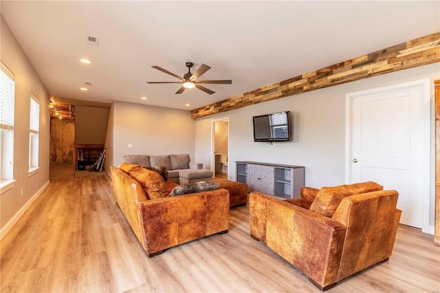 living room featuring ceiling fan and light wood-type flooring