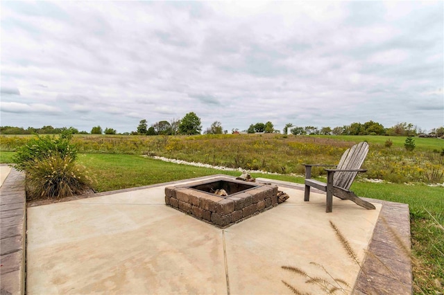 view of patio / terrace with a rural view and an outdoor fire pit