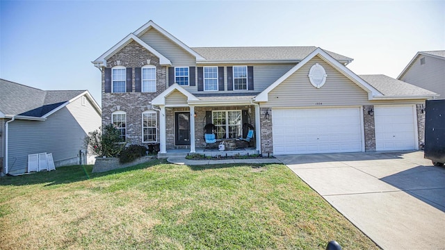 view of front of property featuring a front yard and a garage