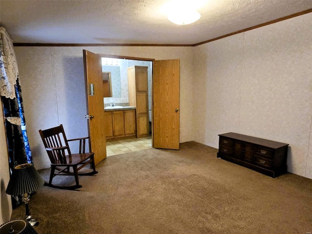 sitting room featuring ornamental molding, lofted ceiling, a textured ceiling, and light colored carpet