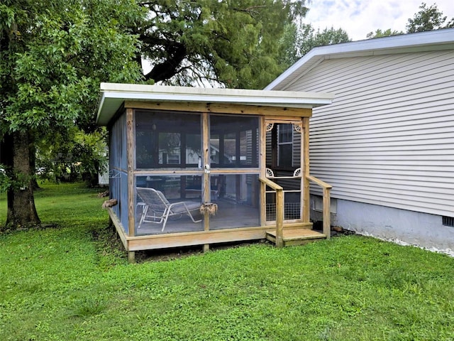 back of house featuring a sunroom and a yard