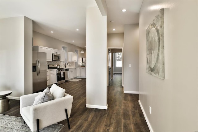 living room featuring sink and dark hardwood / wood-style flooring