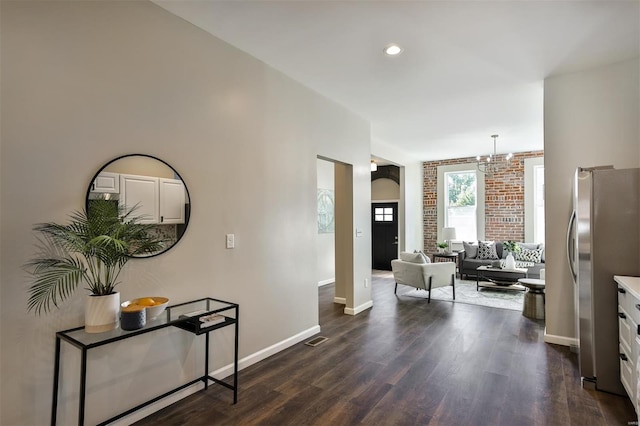 hall with a chandelier and dark hardwood / wood-style flooring