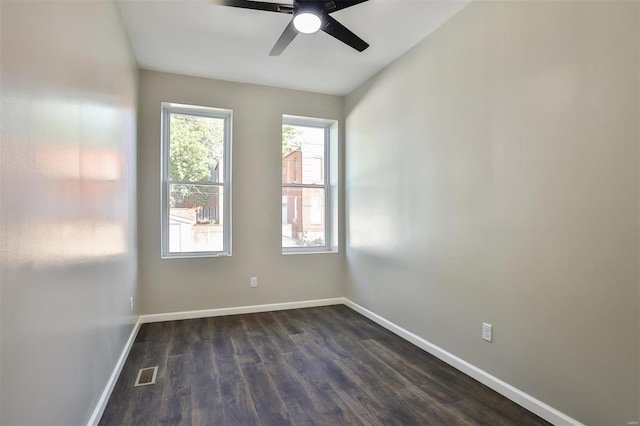 unfurnished room with dark hardwood / wood-style flooring and ceiling fan