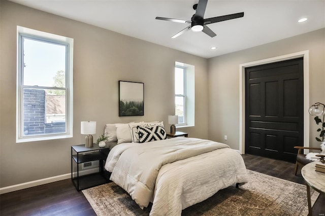 bedroom with ceiling fan and dark hardwood / wood-style flooring