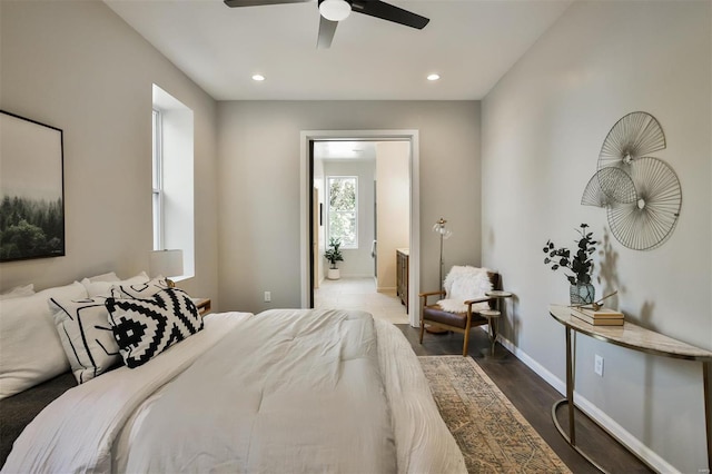 bedroom with dark hardwood / wood-style floors and ceiling fan