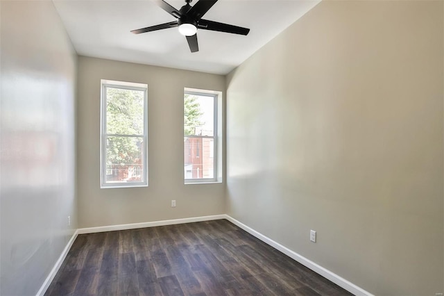 empty room featuring ceiling fan and dark wood-type flooring