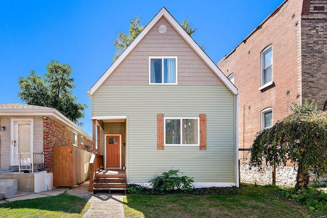 rear view of property featuring a yard