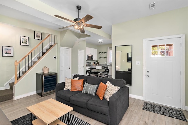 living room with light hardwood / wood-style floors and ceiling fan