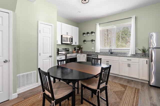 dining room featuring dark hardwood / wood-style flooring and sink