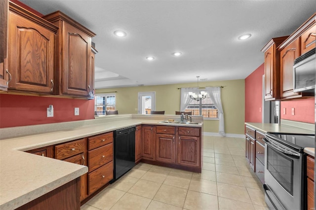 kitchen featuring pendant lighting, sink, appliances with stainless steel finishes, an inviting chandelier, and kitchen peninsula