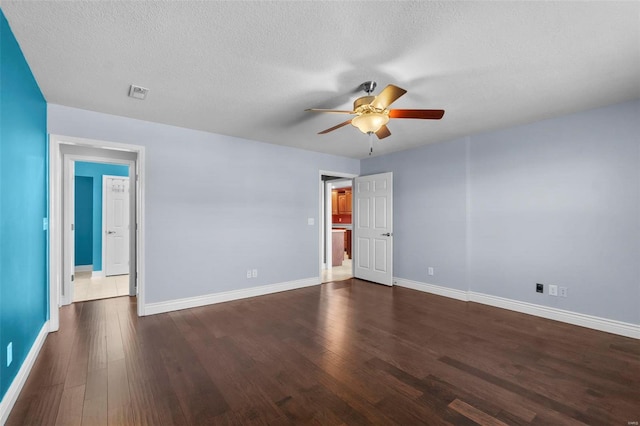 empty room featuring dark hardwood / wood-style floors, a textured ceiling, and ceiling fan