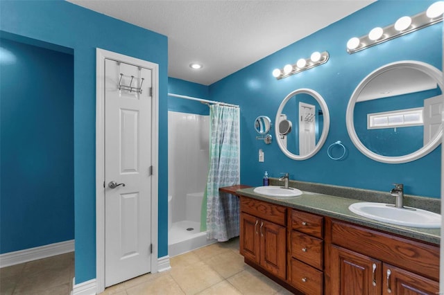 bathroom featuring tile patterned flooring, vanity, a textured ceiling, and a shower with shower curtain