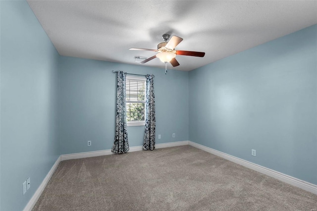 empty room with a textured ceiling, carpet floors, and ceiling fan