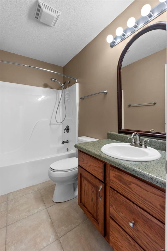 full bathroom featuring shower / bathing tub combination, tile patterned flooring, vanity, toilet, and a textured ceiling