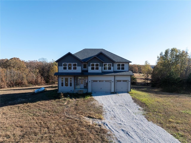 view of property with a garage and a front lawn