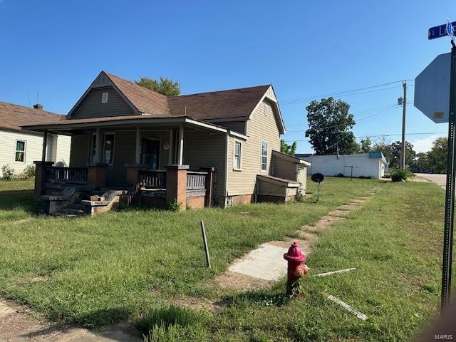 exterior space with a yard and covered porch