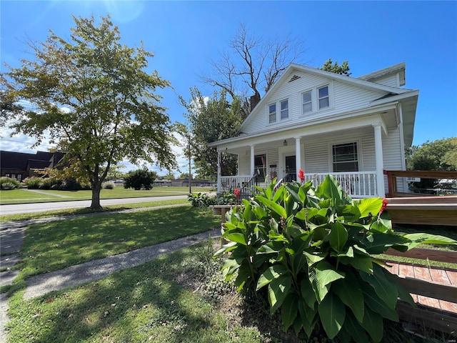 view of front of property with a porch and a front yard