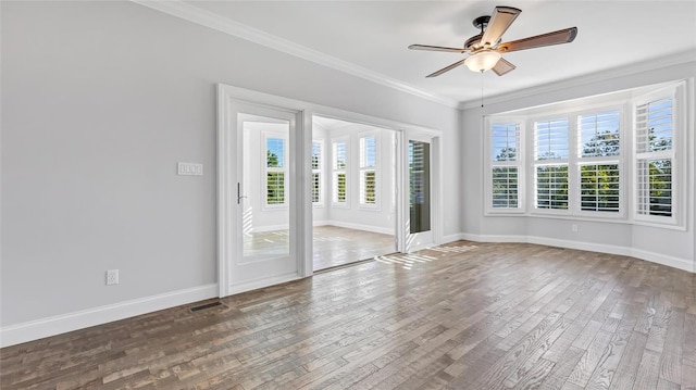 unfurnished room featuring ceiling fan, wood-type flooring, and crown molding