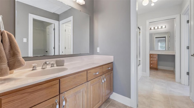 bathroom with tile patterned floors, an enclosed shower, and vanity