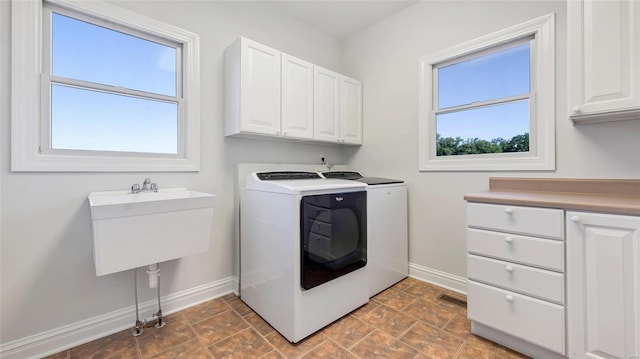 laundry room with cabinets and washer and clothes dryer