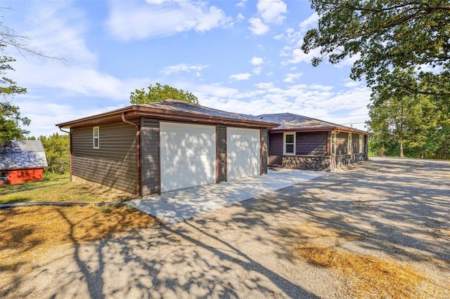 view of front facade with an outbuilding and a garage