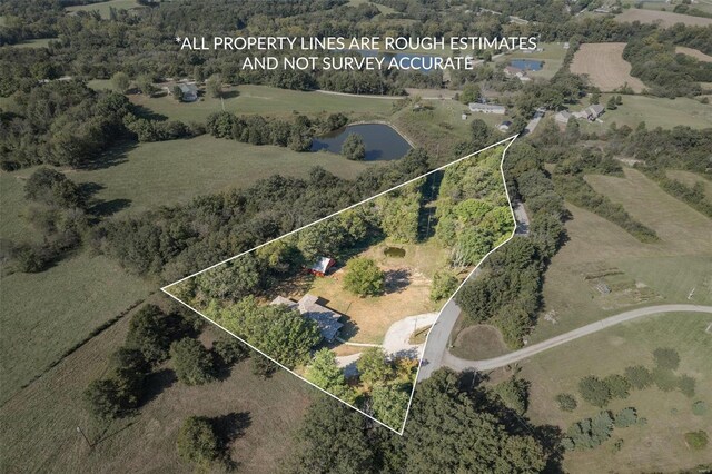 birds eye view of property with a water view and a rural view