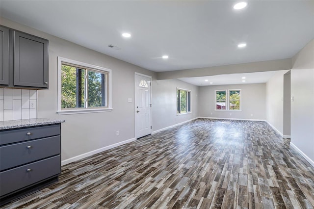 unfurnished living room featuring dark wood-type flooring