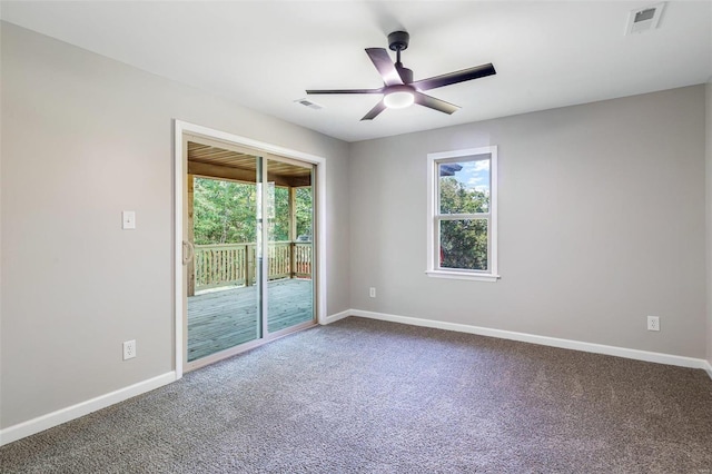 carpeted empty room featuring ceiling fan