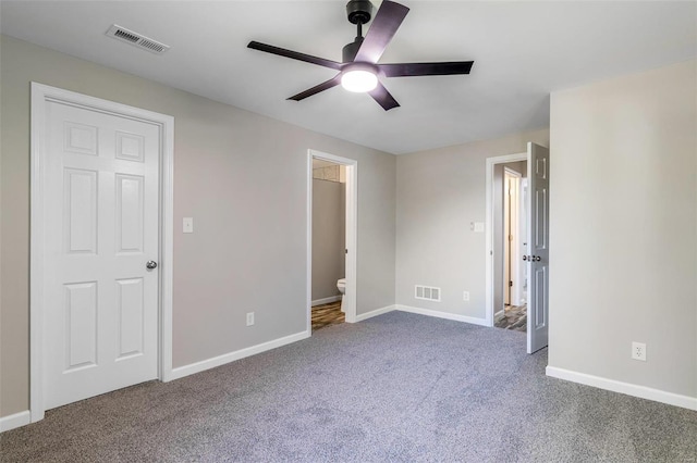 unfurnished bedroom featuring connected bathroom, carpet, and ceiling fan