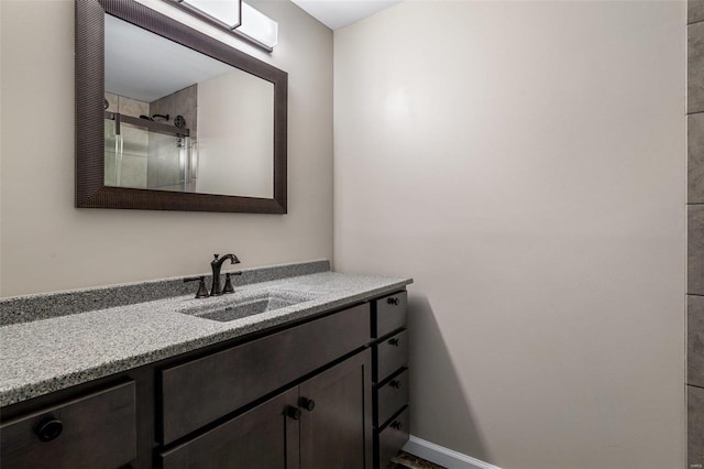 bathroom featuring vanity and an enclosed shower