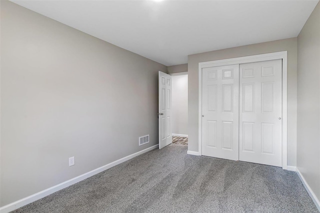 unfurnished bedroom featuring a closet and carpet flooring