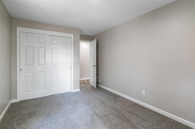 unfurnished bedroom featuring a closet and carpet floors