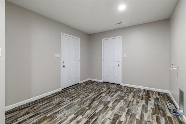 spare room featuring dark hardwood / wood-style flooring